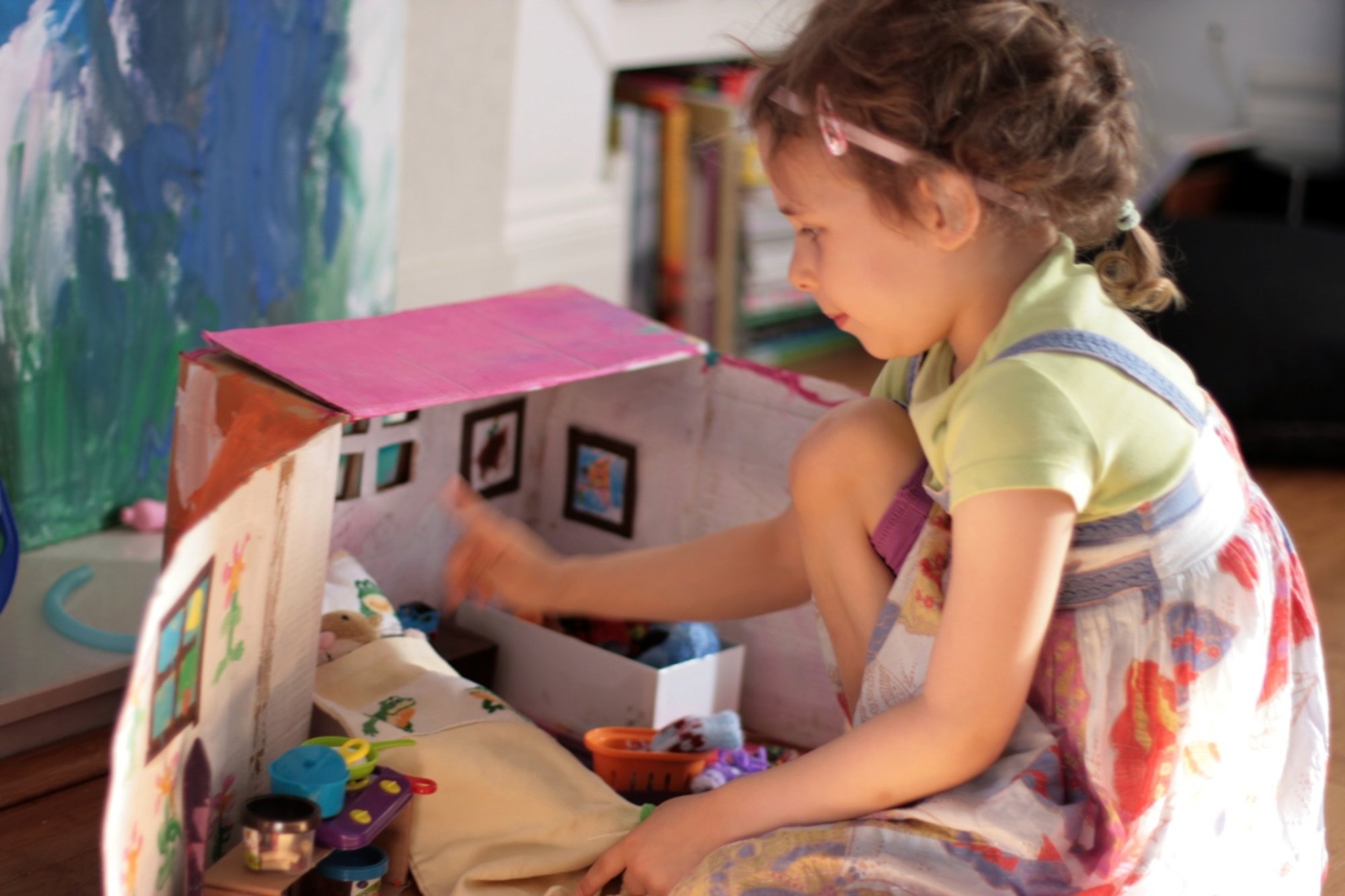 Ava playing with the Hoover-Mouse house